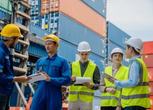 Close-up photo of longshoremen or harbor workers wearing safety gear