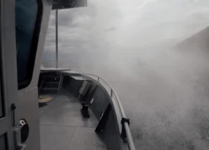 Fishing vessel battling rough waves during storm